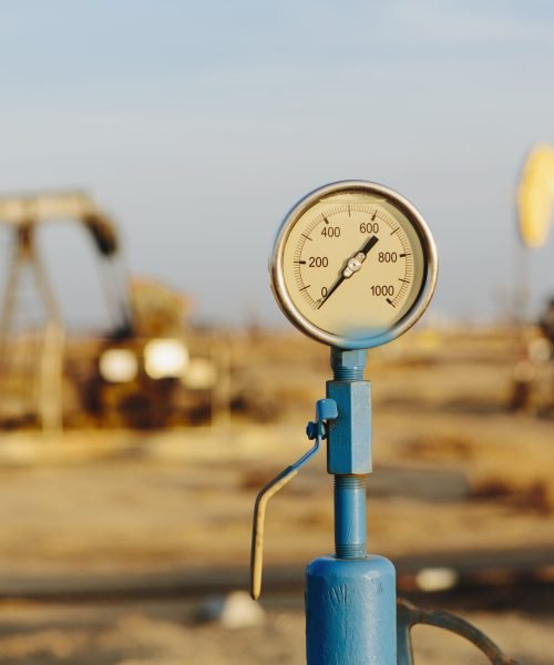 Air pressure gauge, oil rigs in background, Sunset-Midway oil fields, the largest in California.